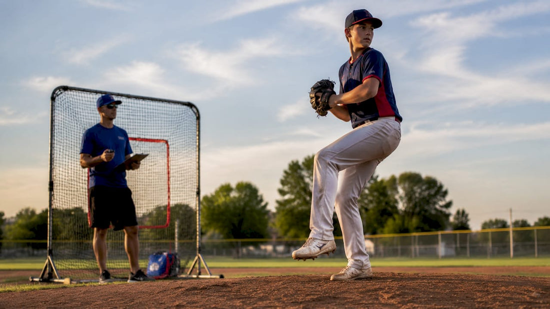 Teen pitcher practicing on mound with coach nearby