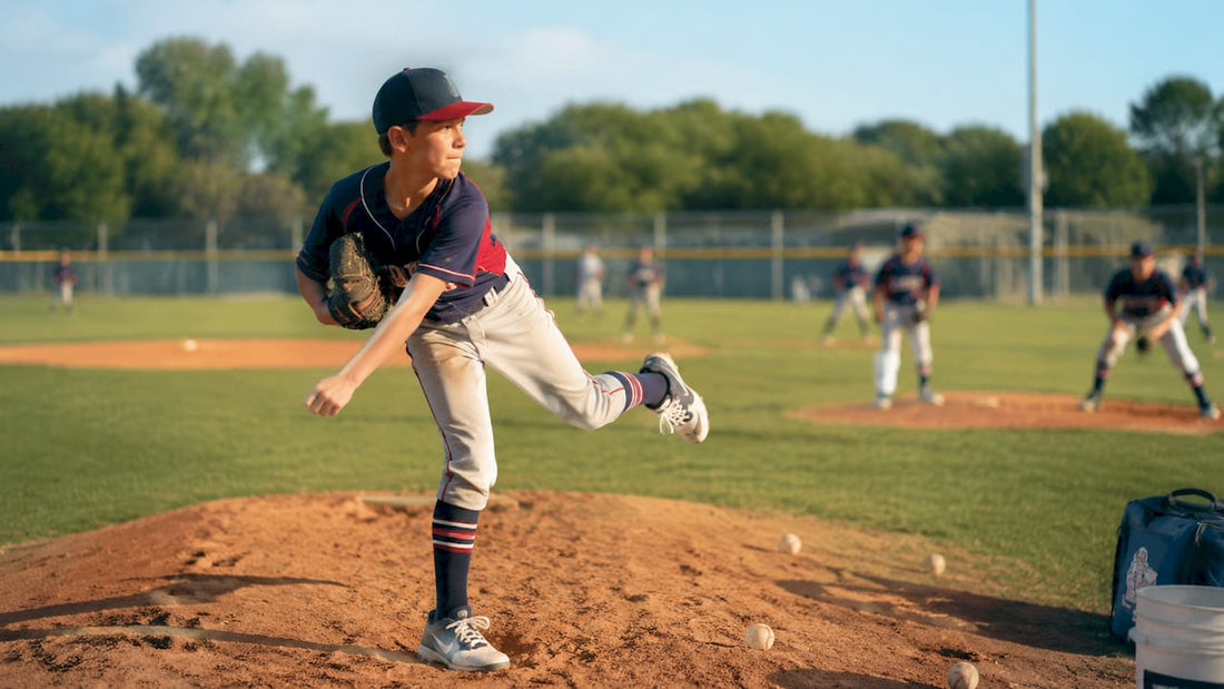 Youth baseball pitcher completing pitch follow-through