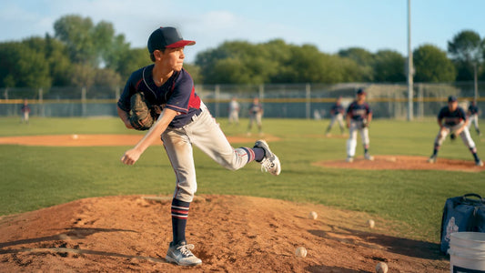 Youth baseball pitcher completing pitch follow-through