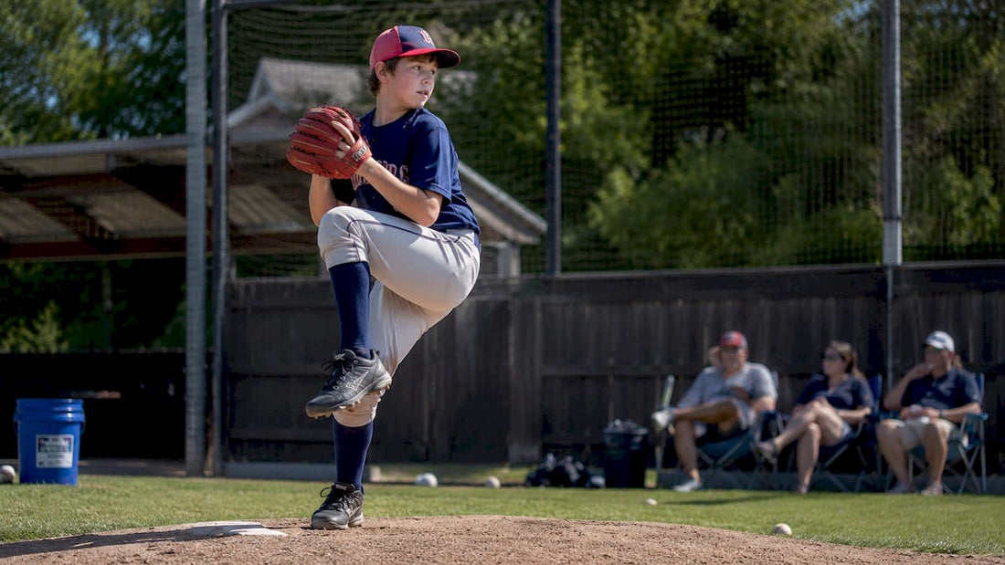 Youth baseball pitcher preparing to throw a pitch