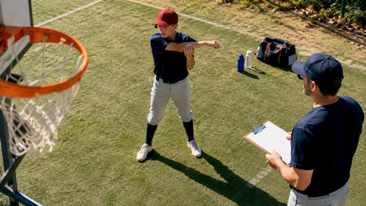 Young baseball player warming up arm outdoors