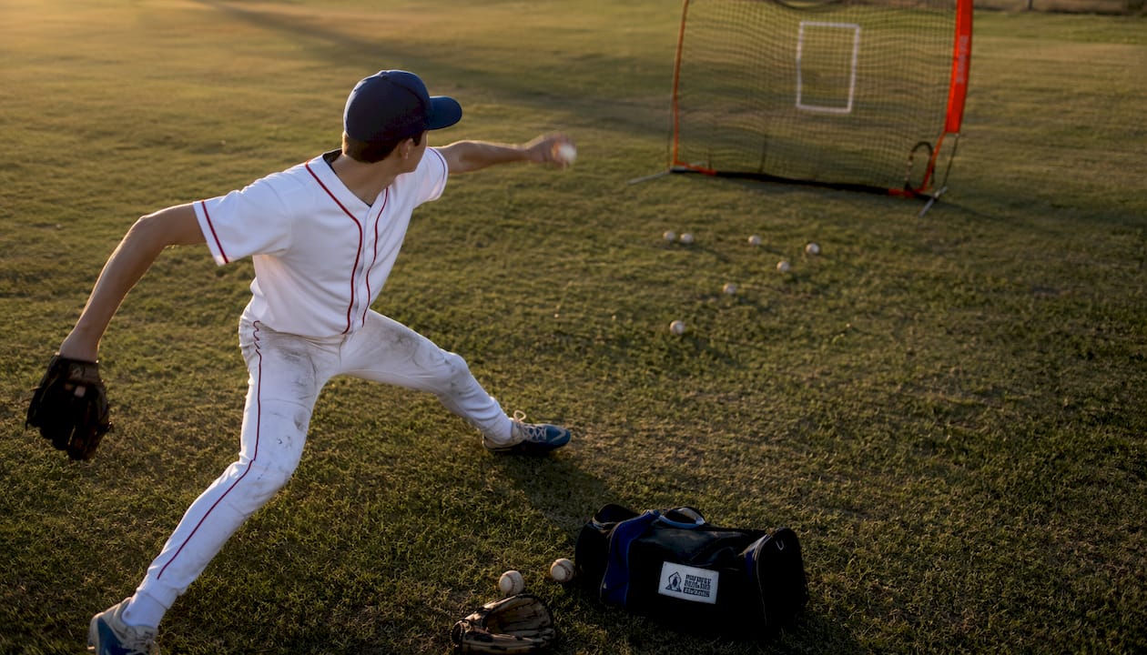 Teen pitcher practicing pitch command drill outdoors