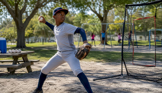 Youth pitcher practicing with portable net outdoors
