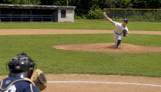 Baseball pitcher throwing slider pitch on field