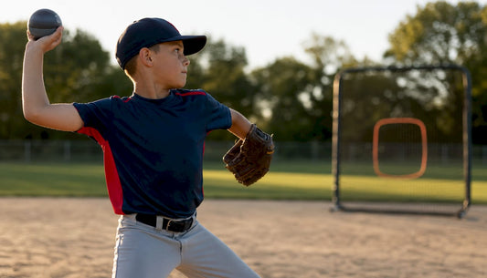 Youth baseball player throwing weighted baseball