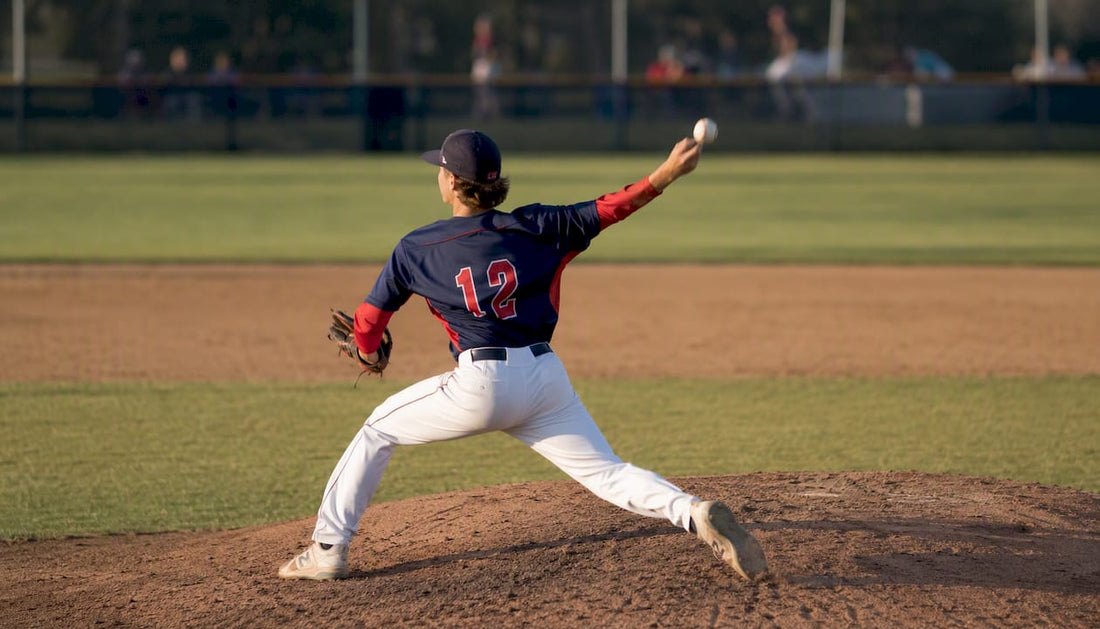Youth pitcher throwing baseball on field