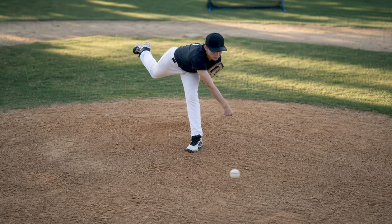 Youth pitcher throwing a slider pitch