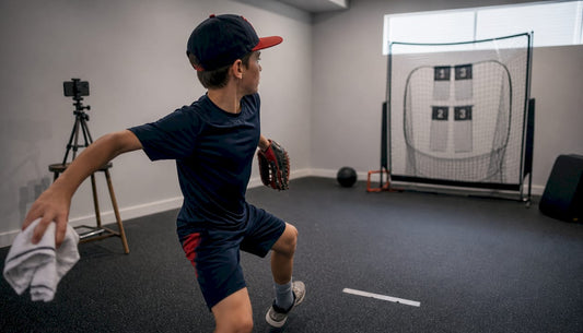 Youth pitcher practicing indoor pitching drills