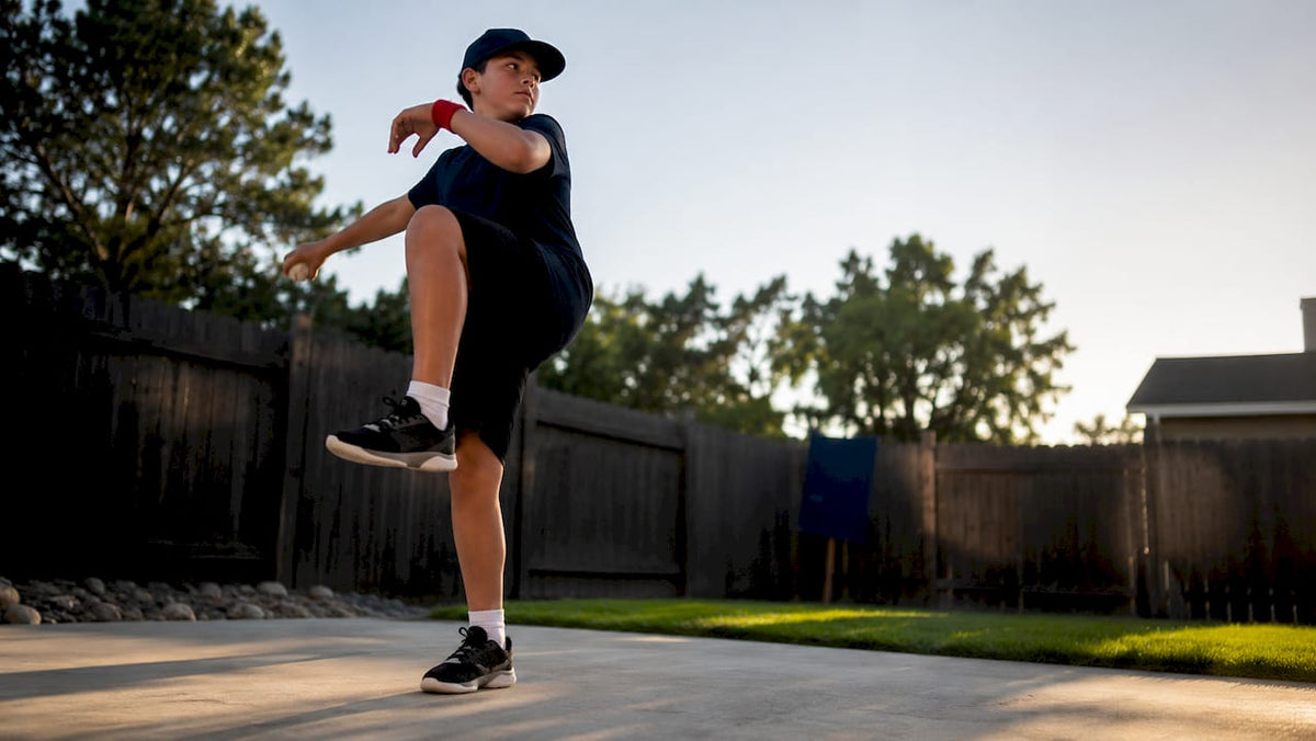 Youth pitcher practicing at home