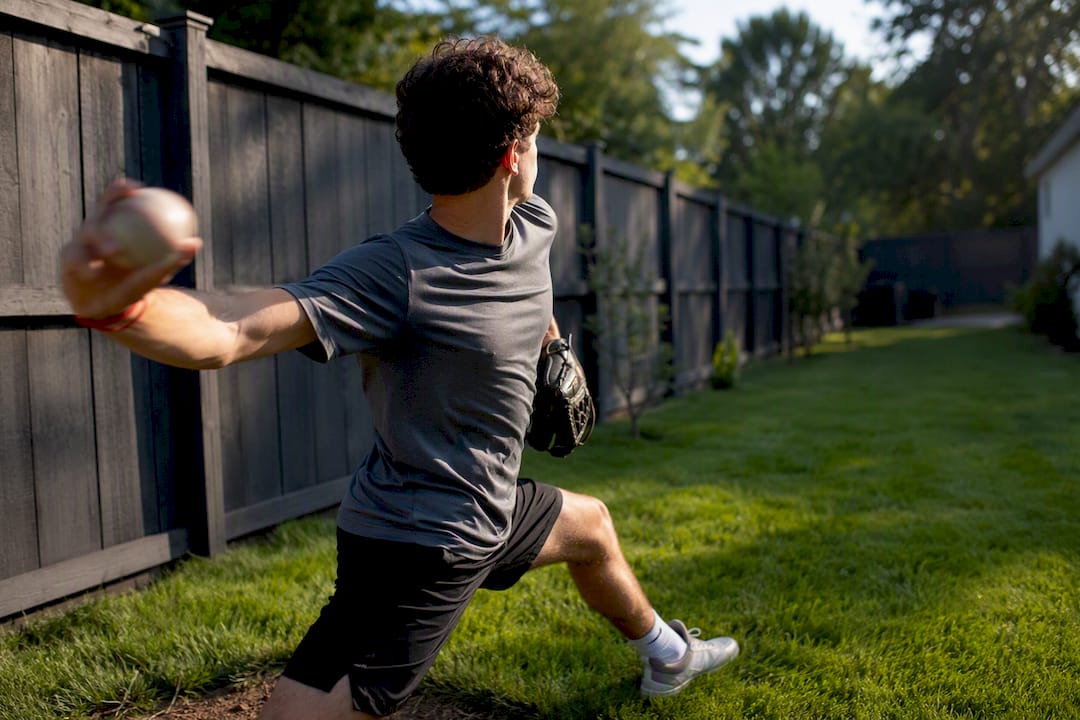Youth pitcher practicing control in backyard