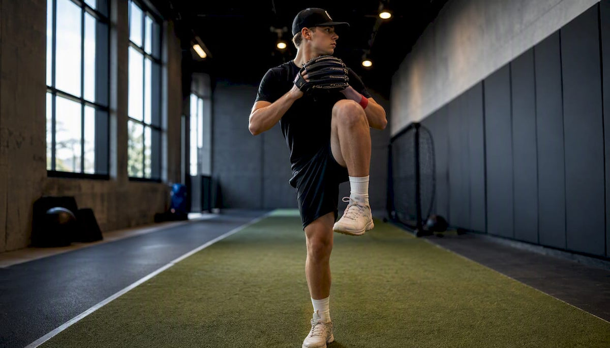 Youth pitcher holding balance position indoors