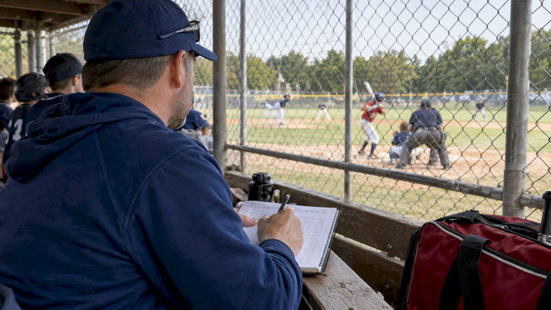 Scorekeeper tracking pitches during youth baseball game