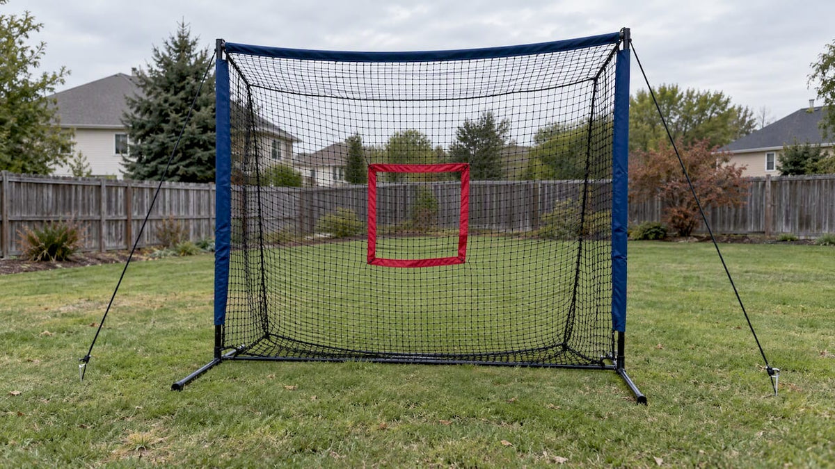 Portable pitching net staked on a lawn