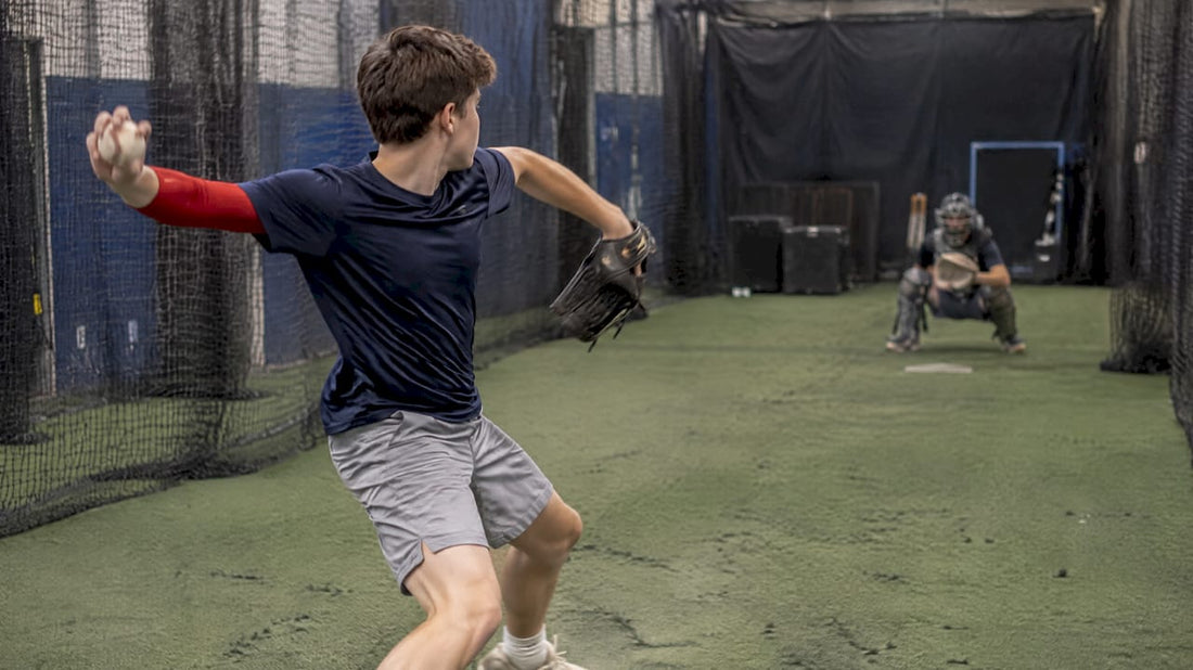 Youth pitcher throwing from level indoor turf